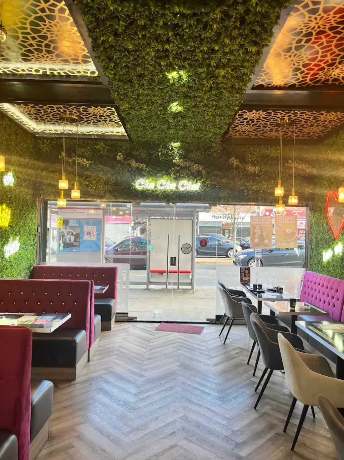 The dining room with its planted ceiling, gold lattice panels and velvet booths